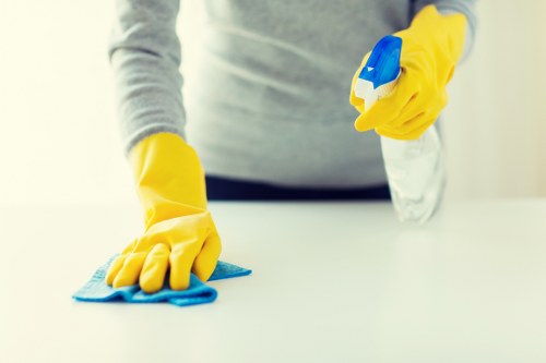Trained cleaner using protective gear during carpet cleaning