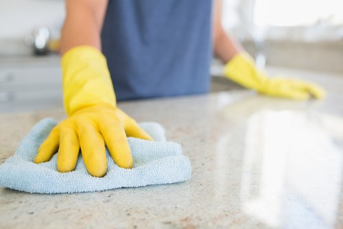 Technician performing upholstery cleaning on a chair